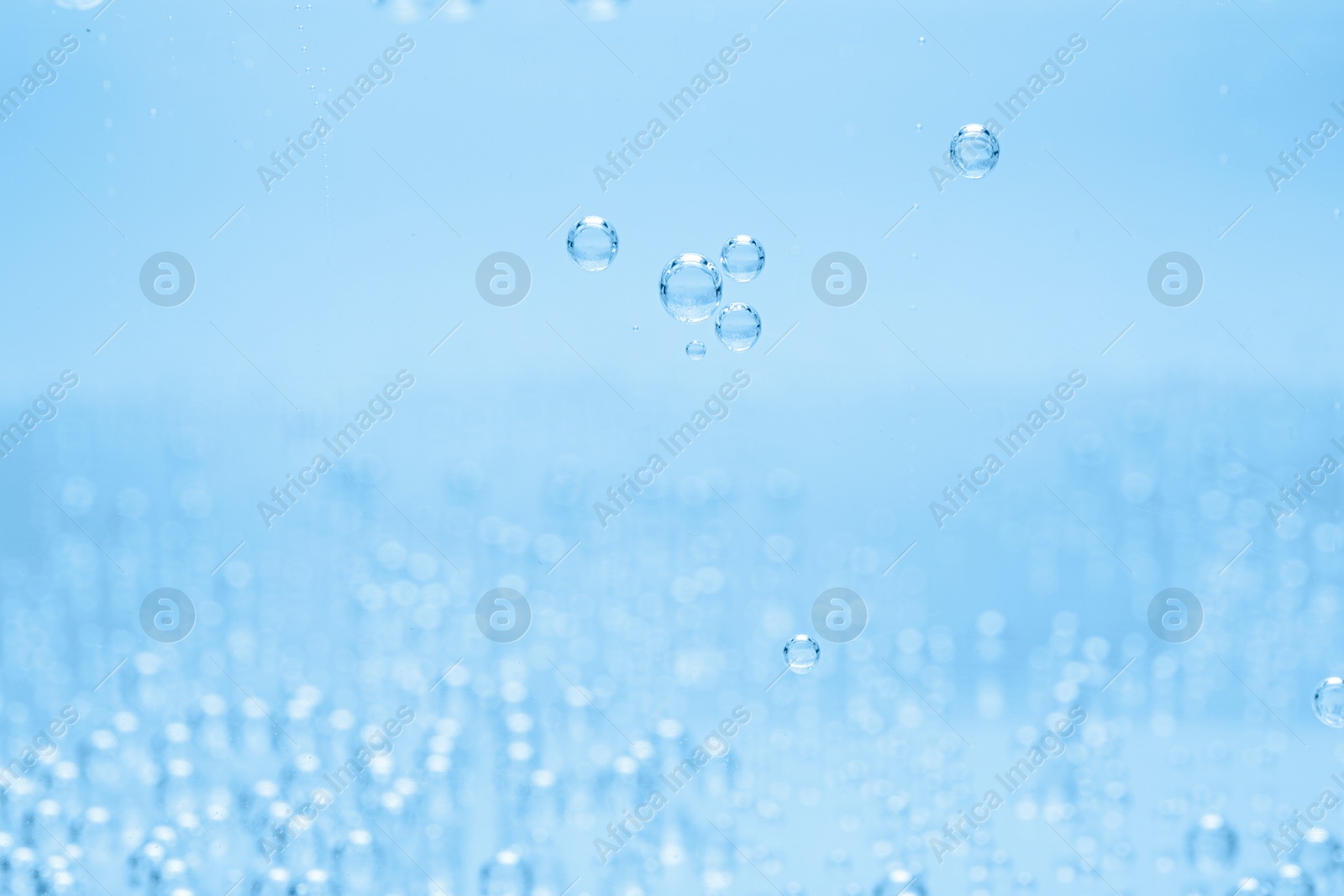 Soda water with bubbles as background, closeup Image of Soda water with bubbles as background, closeup