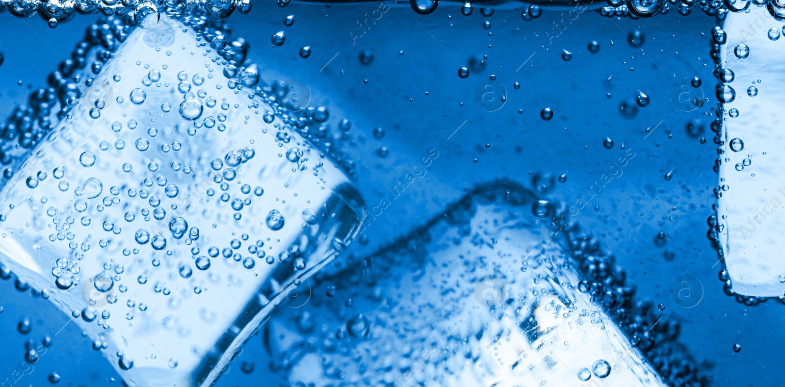 Soda water with ice cubes as background, closeup Image of Soda water with ice cubes as background, closeup
