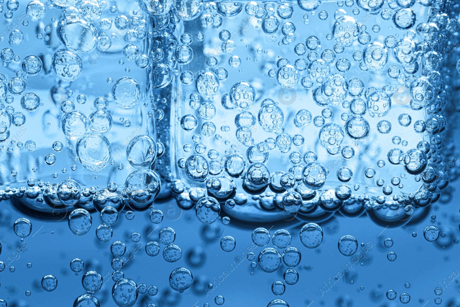 Soda water with ice cubes as background, closeup Image of Soda water with ice cubes as background, closeup