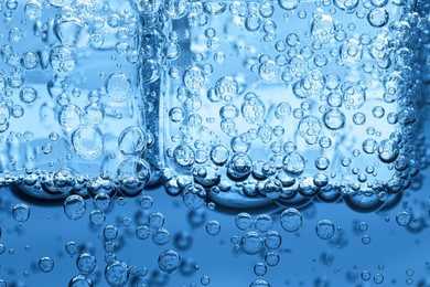 Image of Soda water with ice cubes as background, closeup