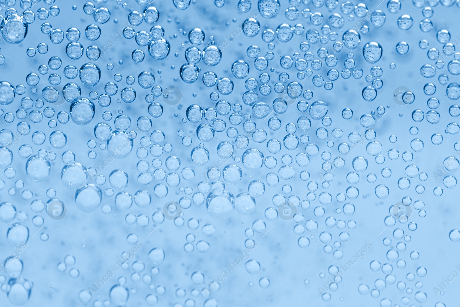 Soda water with bubbles as background, closeup Image of Soda water with bubbles as background, closeup