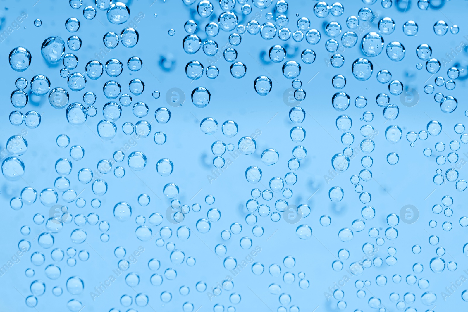Soda water with bubbles as background, closeup Image of Soda water with bubbles as background, closeup