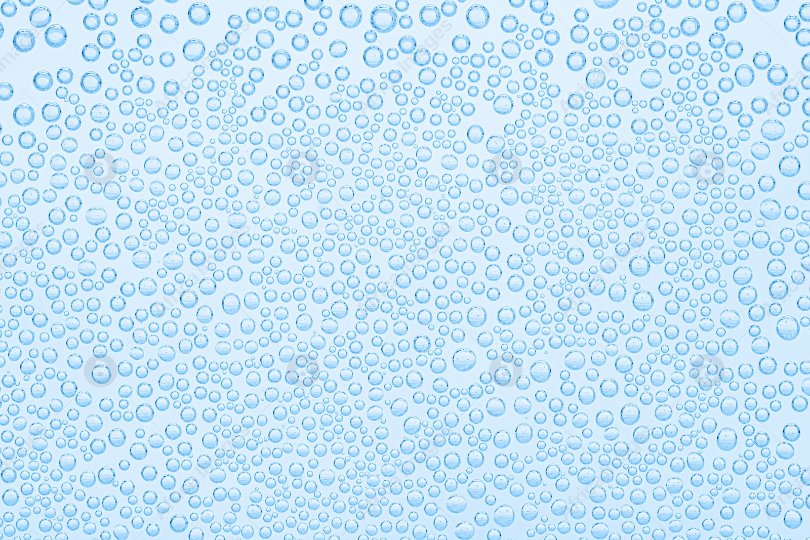 Soda water with bubbles as background, closeup Image of Soda water with bubbles as background, closeup