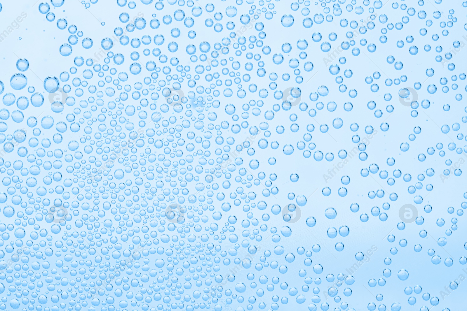 Soda water with bubbles as background, closeup Image of Soda water with bubbles as background, closeup