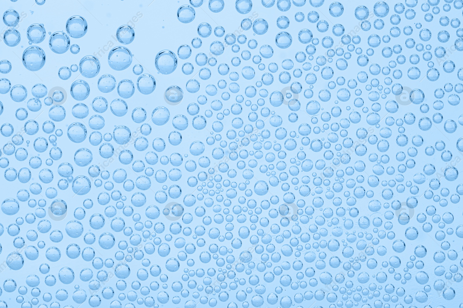 Soda water with bubbles as background, closeup Image of Soda water with bubbles as background, closeup