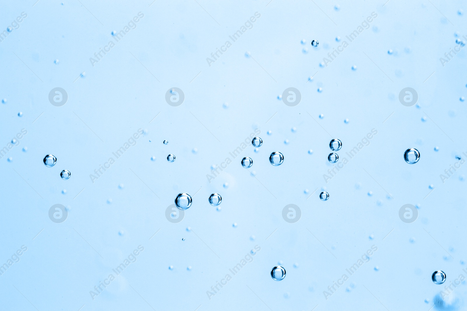Soda water with bubbles as background, closeup Image of Soda water with bubbles as background, closeup