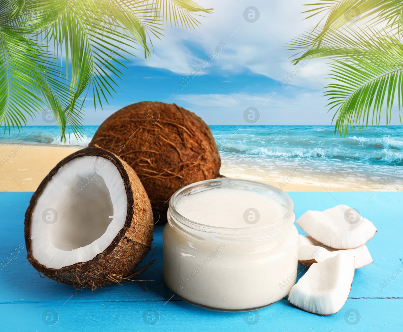 Cooking oil in jar and coconuts on blue table against beach Image of Cooking oil in jar and coconuts on blue table against beach