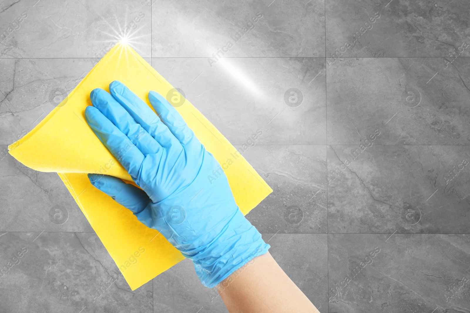 Cleaning service worker in rubber glove washing grey tiled wall with rag, closeup. Shine of purity on cloth Image of Cleaning service worker in rubber glove washing grey tiled wall with rag, closeup. Shine of purity on cloth