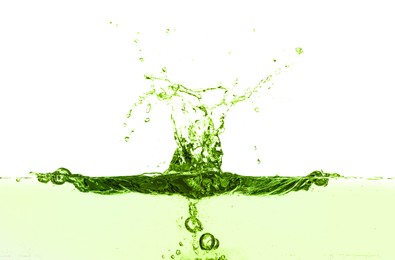 Image of Beautiful green water splashing against white background