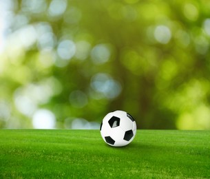 Image of Soccer ball on green grass outdoors. Football game