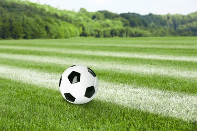 Image of Soccer ball on football field with markings outdoors