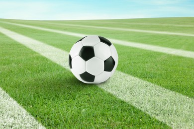 Image of Soccer ball on football field with markings outdoors