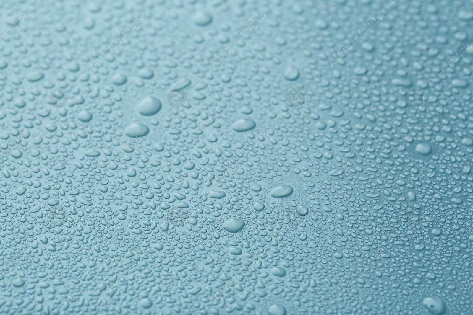 Image of Many water drops on light blue background