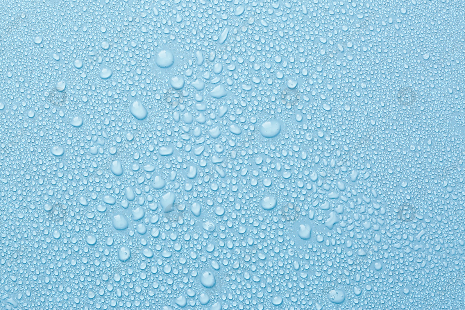 Many water drops on light blue background Image of Many water drops on light blue background
