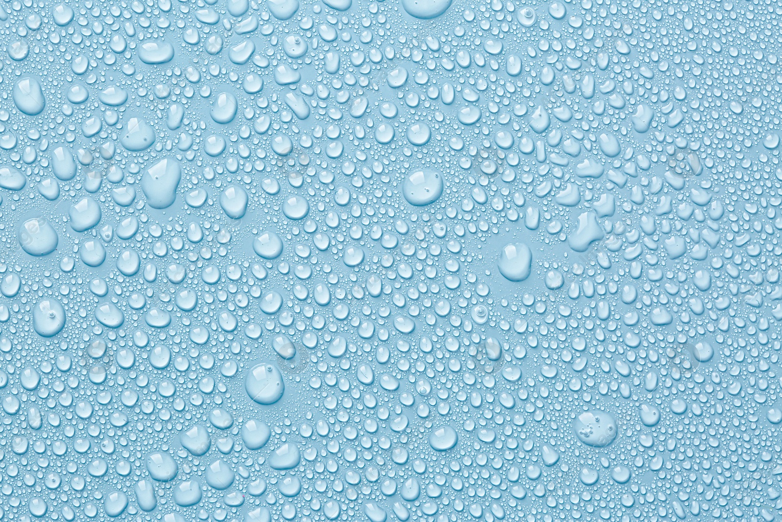 Image of Many water drops on light blue background