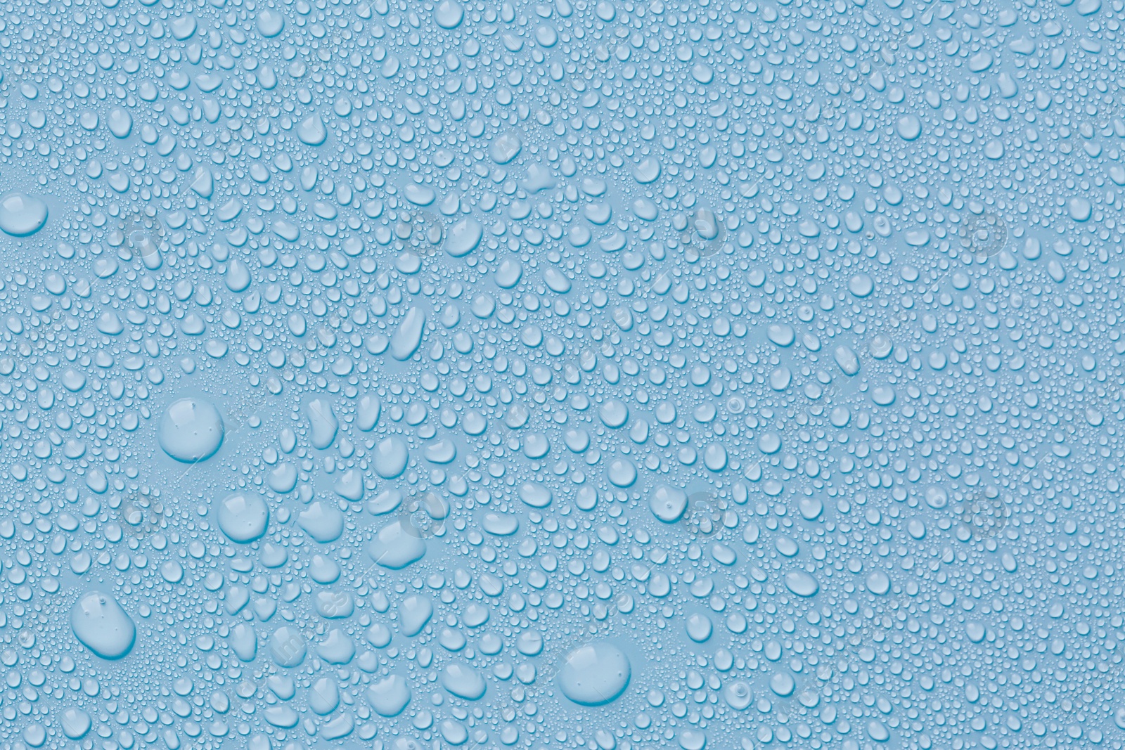 Many water drops on light blue background Image of Many water drops on light blue background