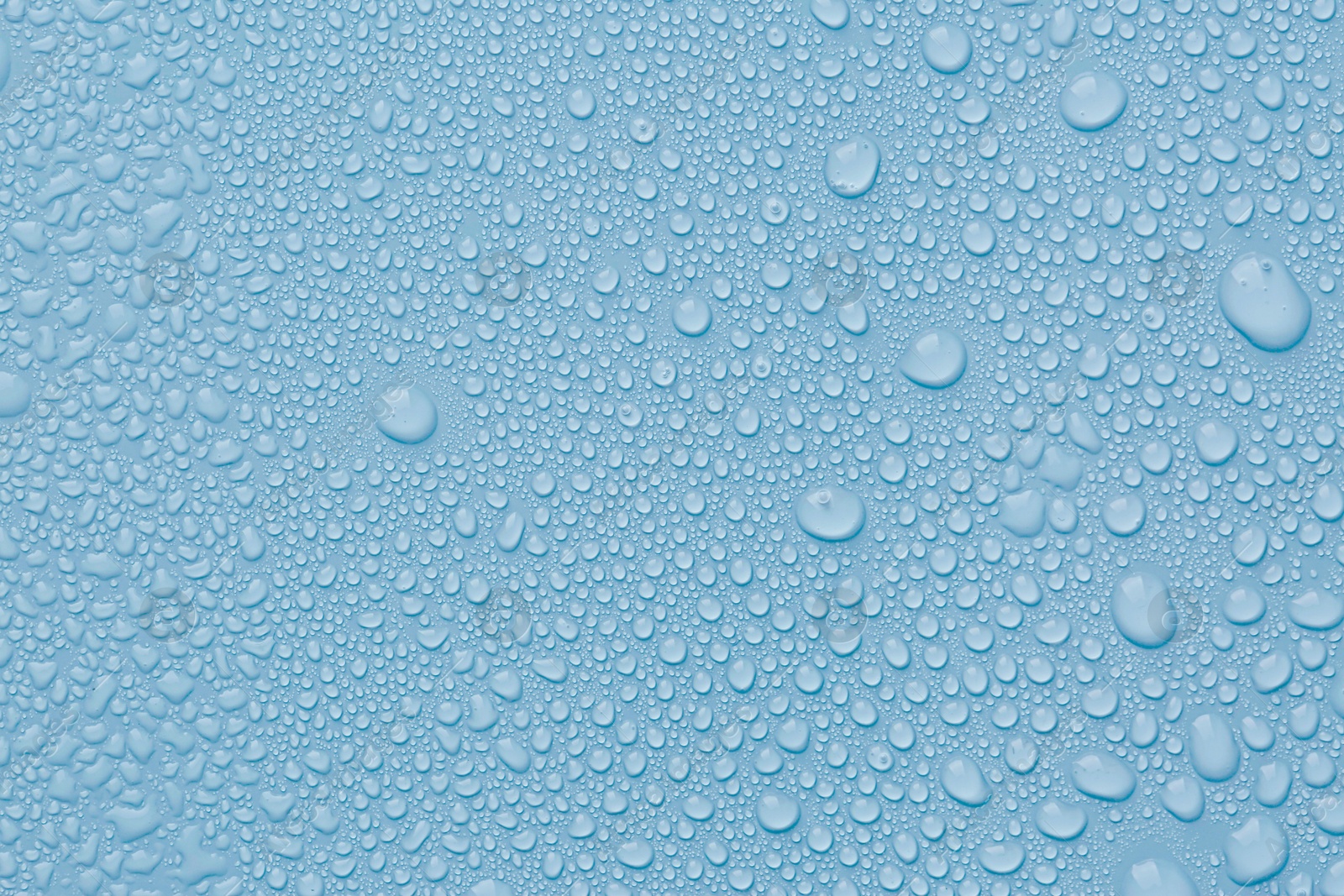 Many water drops on light blue background Image of Many water drops on light blue background