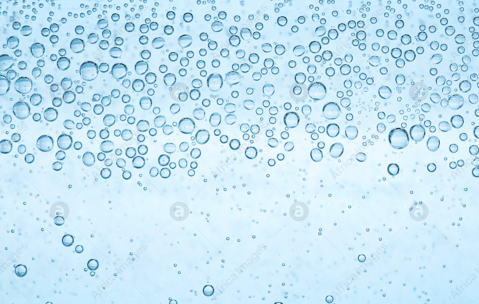 Soda water with bubbles as background, closeup Image of Soda water with bubbles as background, closeup