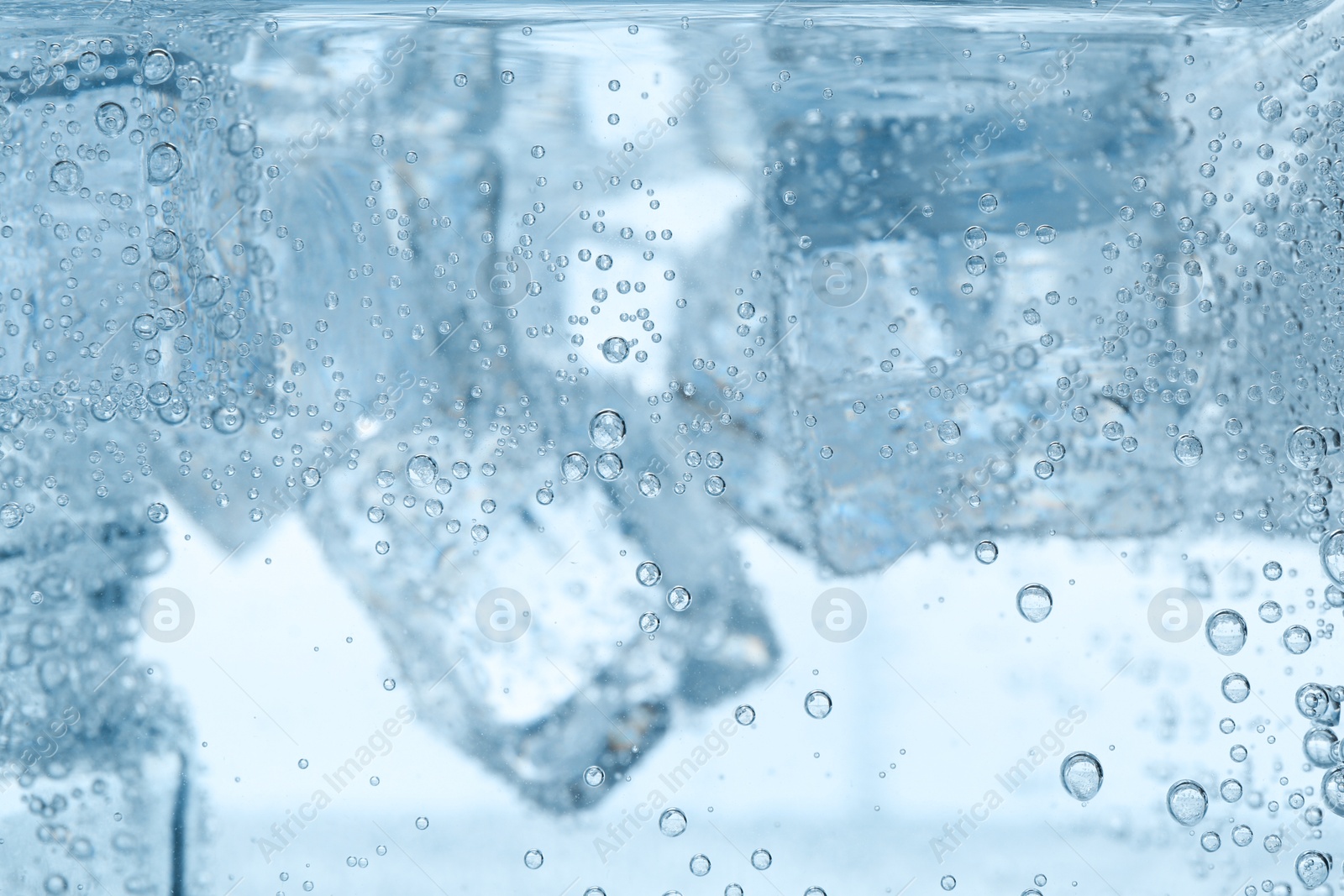Refreshing soda water with ice cubes as background, closeup Image of Refreshing soda water with ice cubes as background, closeup