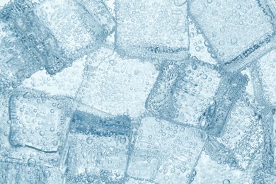 Image of Refreshing soda water with ice cubes as background, closeup