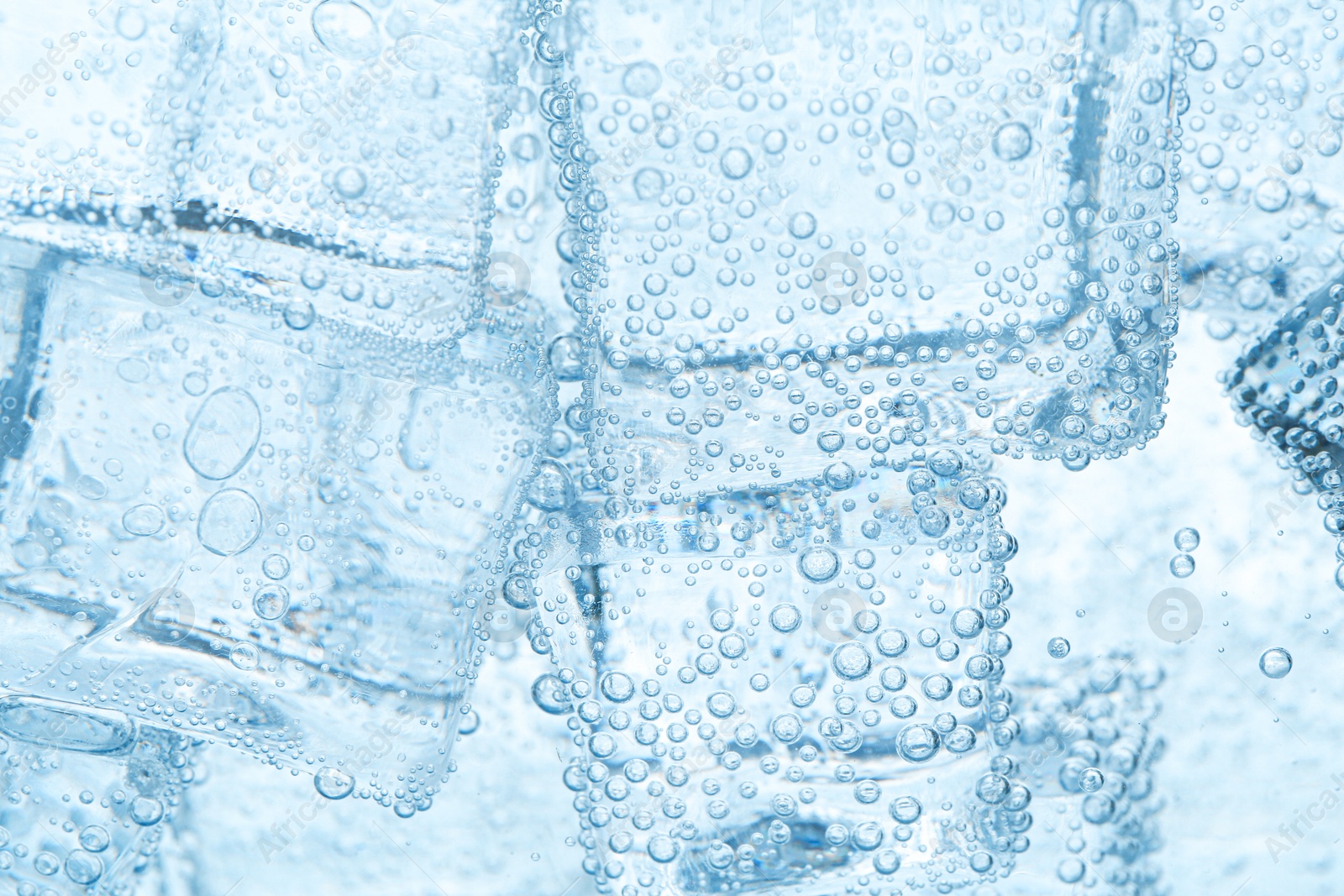 Refreshing soda water with ice cubes as background, closeup Image of Refreshing soda water with ice cubes as background, closeup