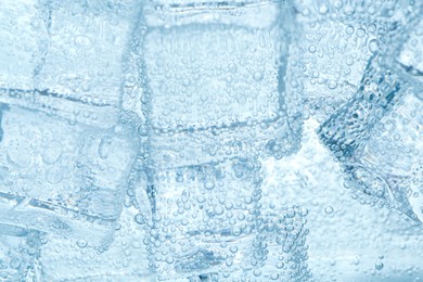 Image of Refreshing soda water with ice cubes as background, closeup