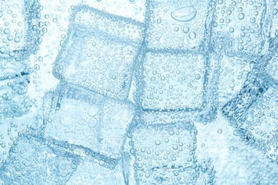 Image of Refreshing soda water with ice cubes as background, closeup