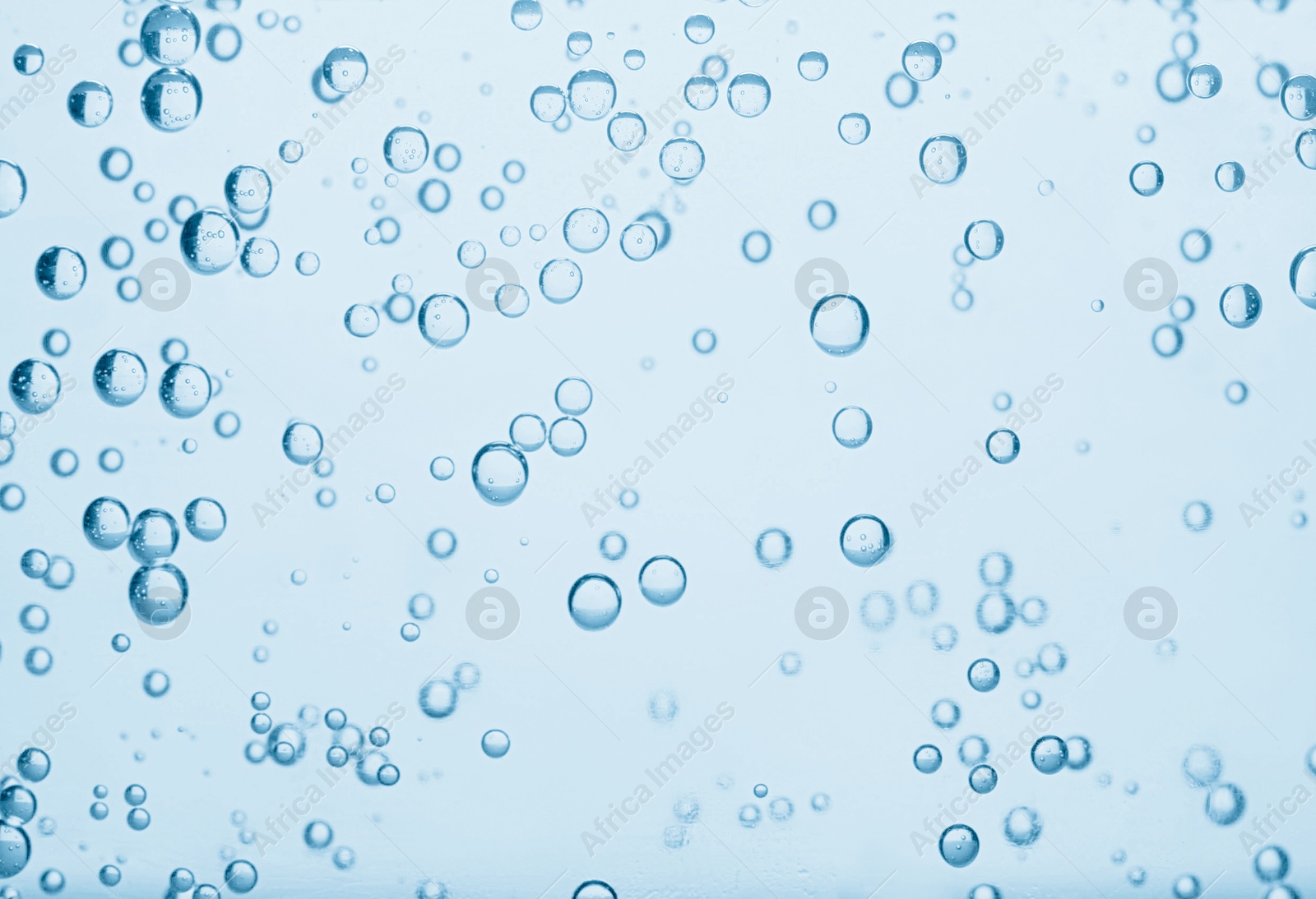 Soda water with bubbles as background, closeup Image of Soda water with bubbles as background, closeup