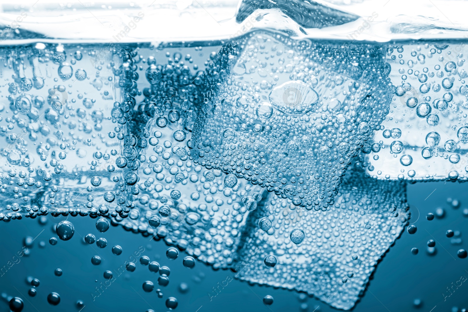 Soda water with ice cubes as background, closeup Image of Soda water with ice cubes as background, closeup