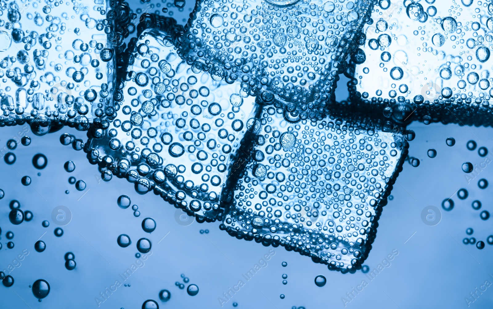 Soda water with ice cubes as background, closeup Image of Soda water with ice cubes as background, closeup
