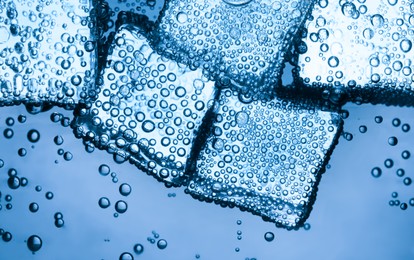 Image of Soda water with ice cubes as background, closeup
