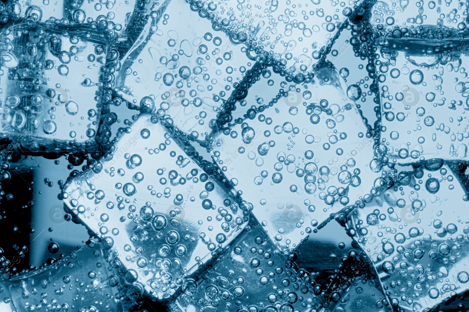 Soda water with ice cubes as background, closeup Image of Soda water with ice cubes as background, closeup