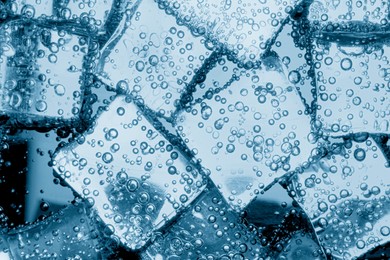 Image of Soda water with ice cubes as background, closeup