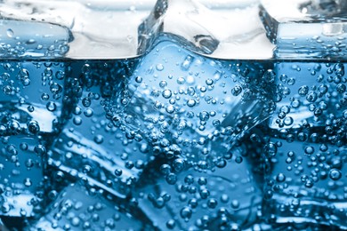 Image of Soda water with ice cubes as background, closeup