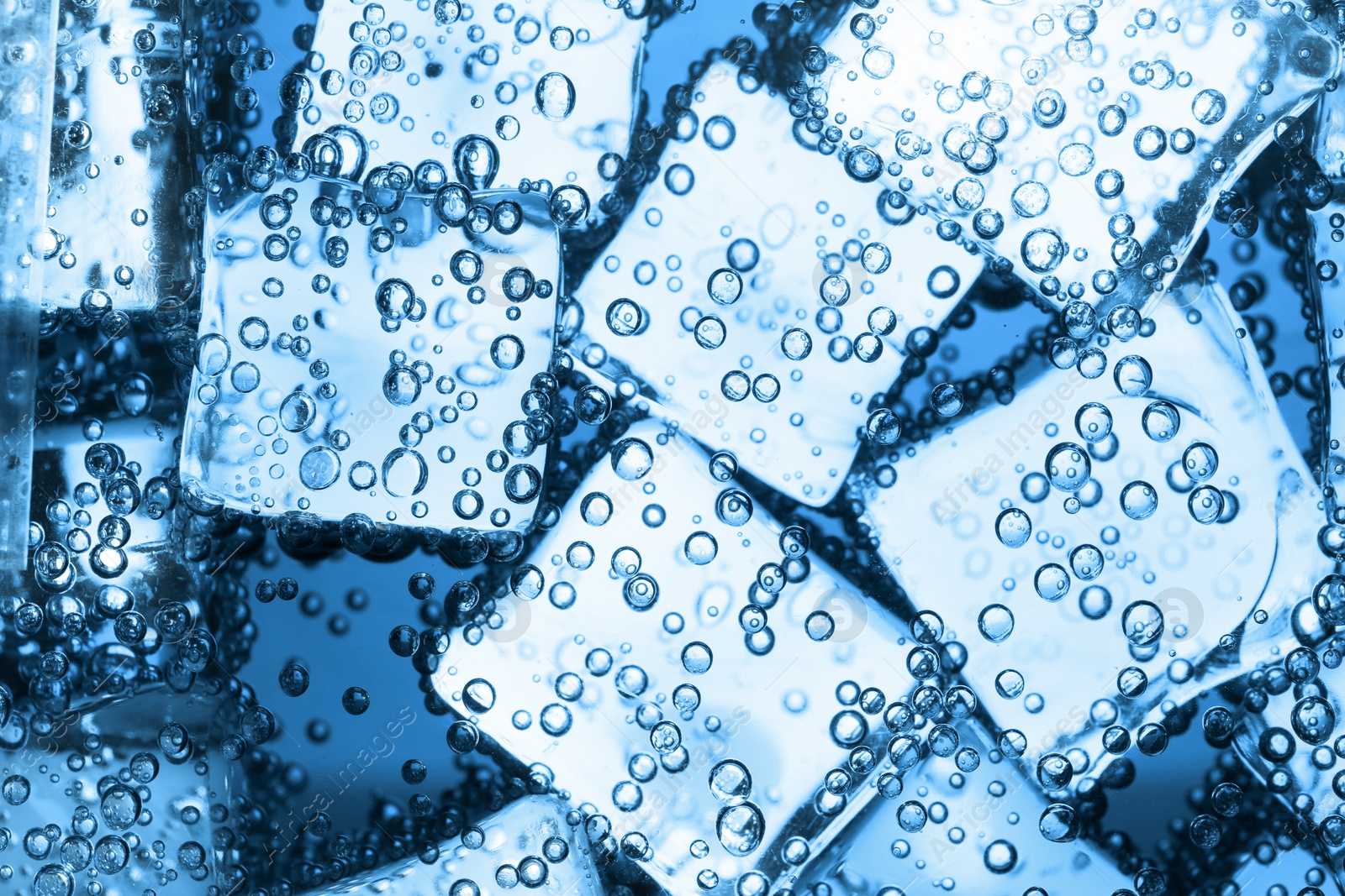 Soda water with ice cubes as background, closeup Image of Soda water with ice cubes as background, closeup