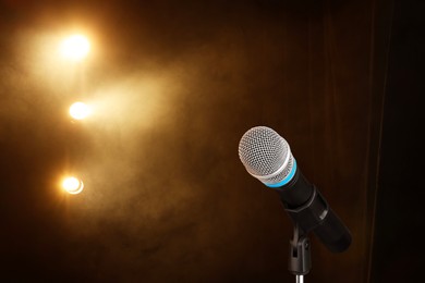 Image of Microphone on stage in smoke under spotlights. Singer's performance
