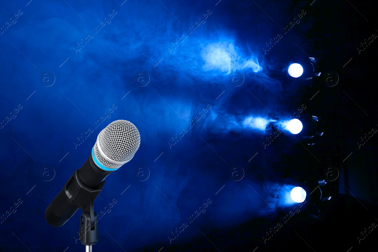 Microphone on stage in smoke under spotlights. Singer's performance Image of Microphone on stage in smoke under spotlights. Singer's performance