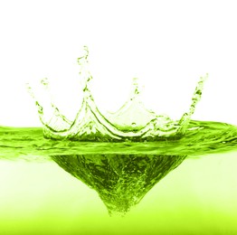 Image of Beautiful green water splashing against white background