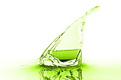 Image of Beautiful green water splashing against white background