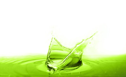 Image of Beautiful green water splashing against white background