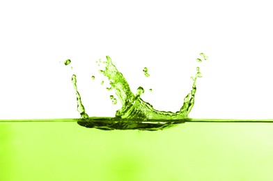 Image of Beautiful green water splashing against white background