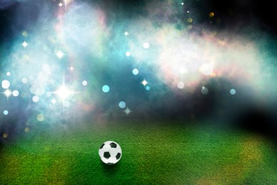 Image of Soccer ball on green grass at football stadium, space for text