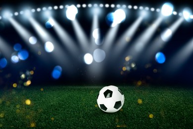 Image of Soccer ball on green grass at stadium. Football game