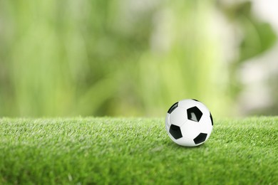Image of Soccer ball on green grass outdoors, space for text. Football game