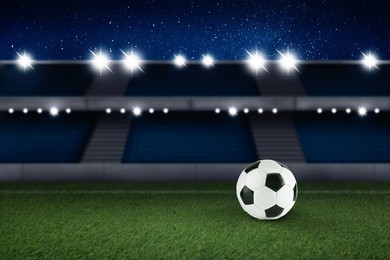 Image of Soccer ball on green grass at football stadium