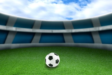 Image of Soccer ball on green grass at football stadium