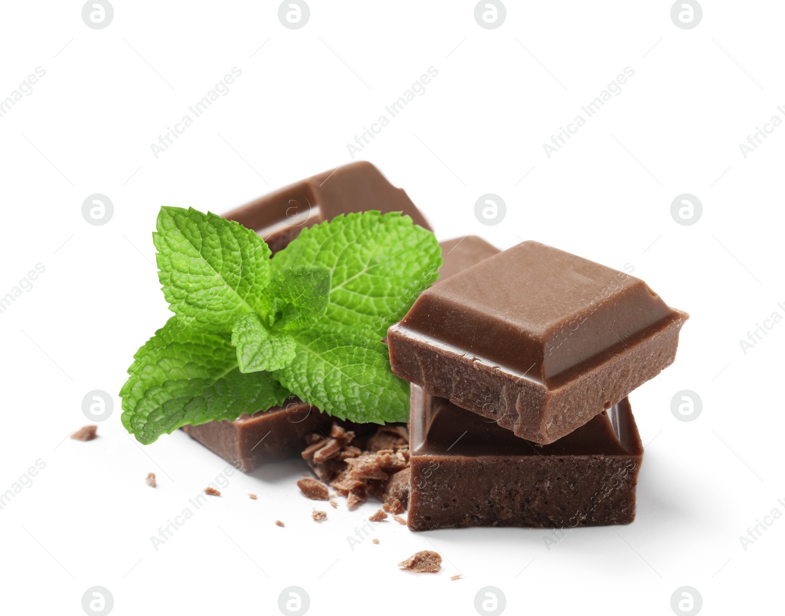 Milk chocolate pieces and mint leaves on white background Image of Milk chocolate pieces and mint leaves on white background