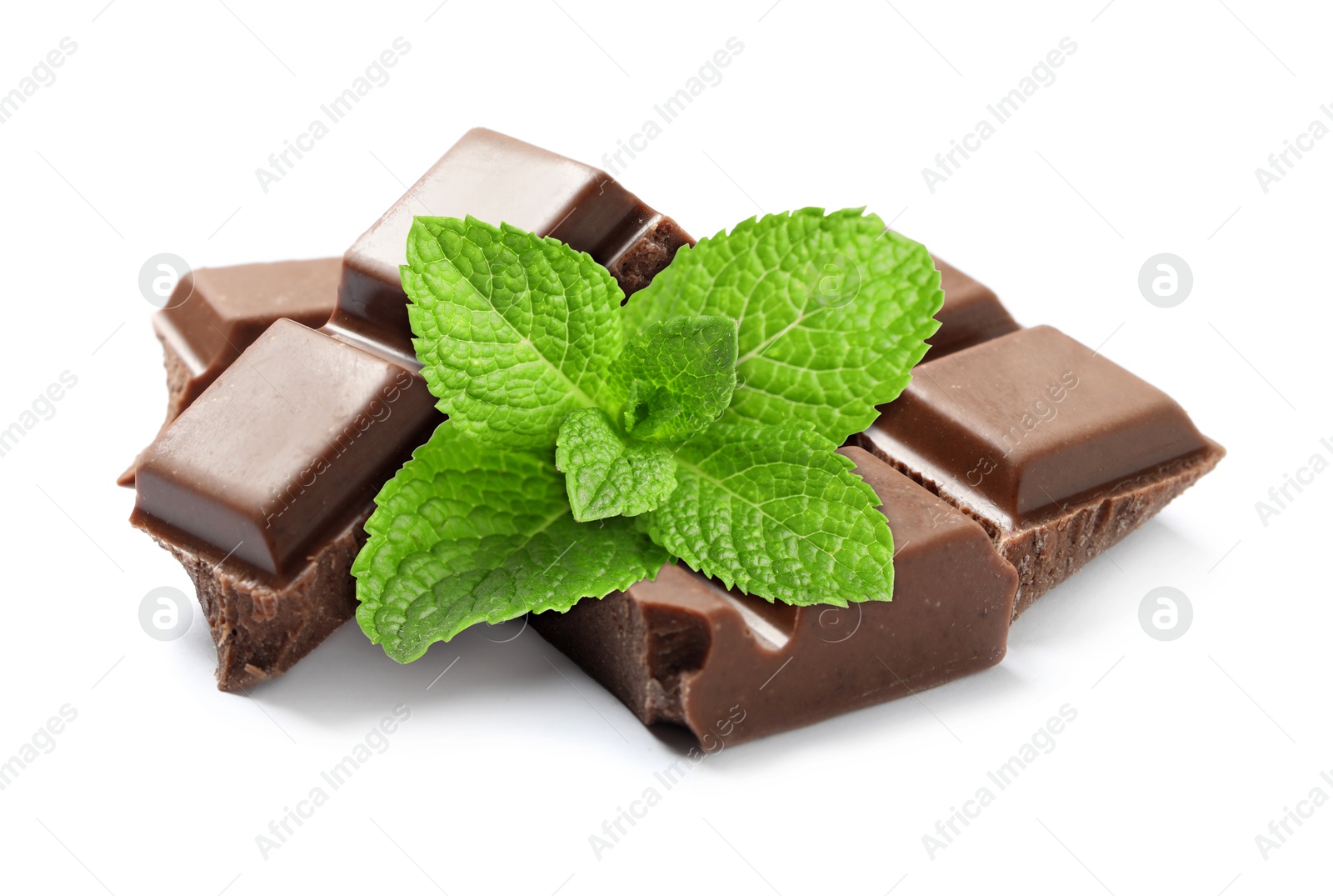 Milk chocolate pieces and mint leaves on white background Image of Milk chocolate pieces and mint leaves on white background