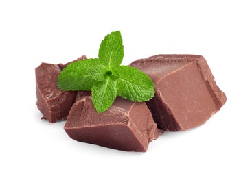 Image of Milk chocolate chunks and mint leaves on white background