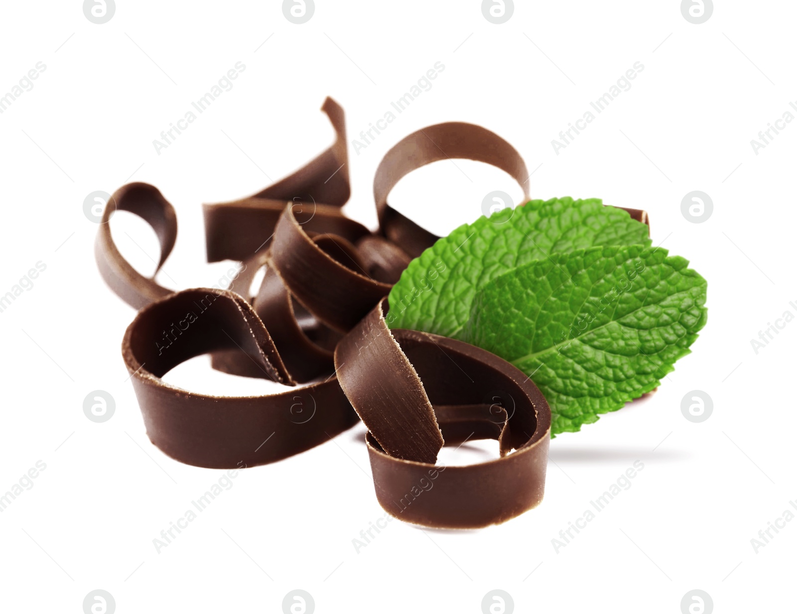 Milk chocolate curls and mint leaves on white background Image of Milk chocolate curls and mint leaves on white background
